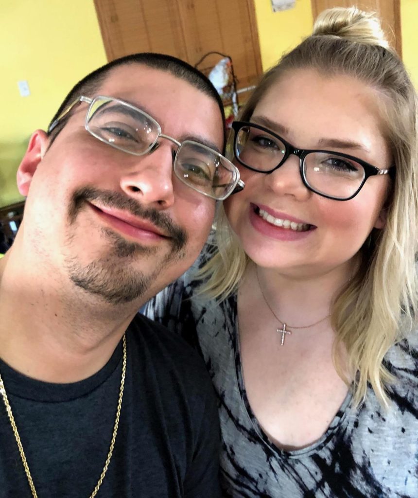 selfie of smiling man and woman wearing glasses