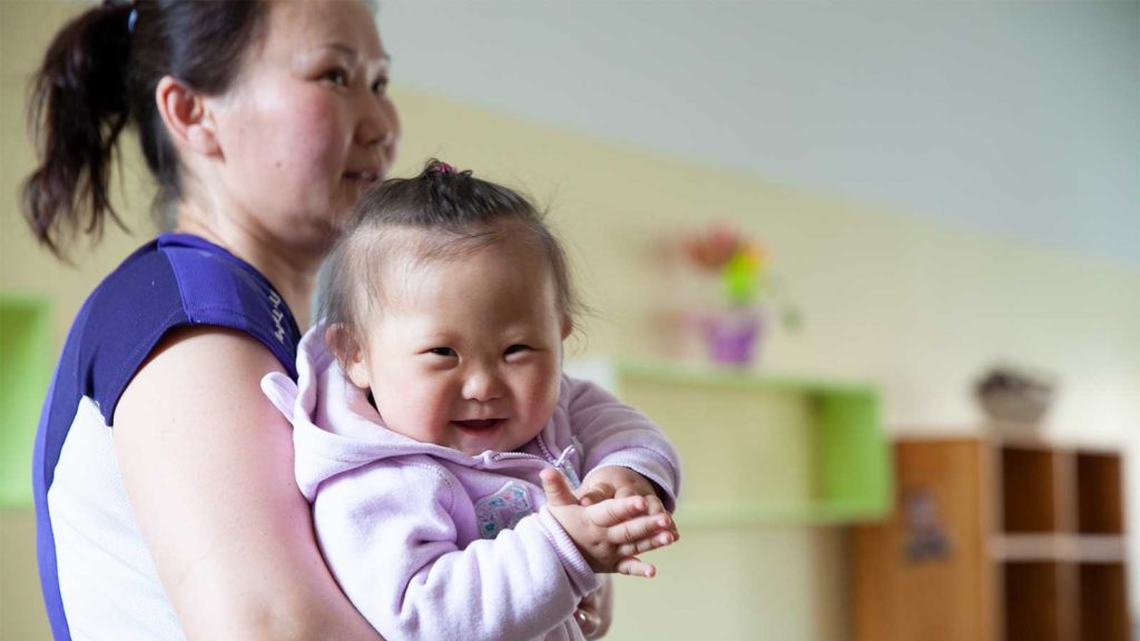 Woman holding baby in Mongolia