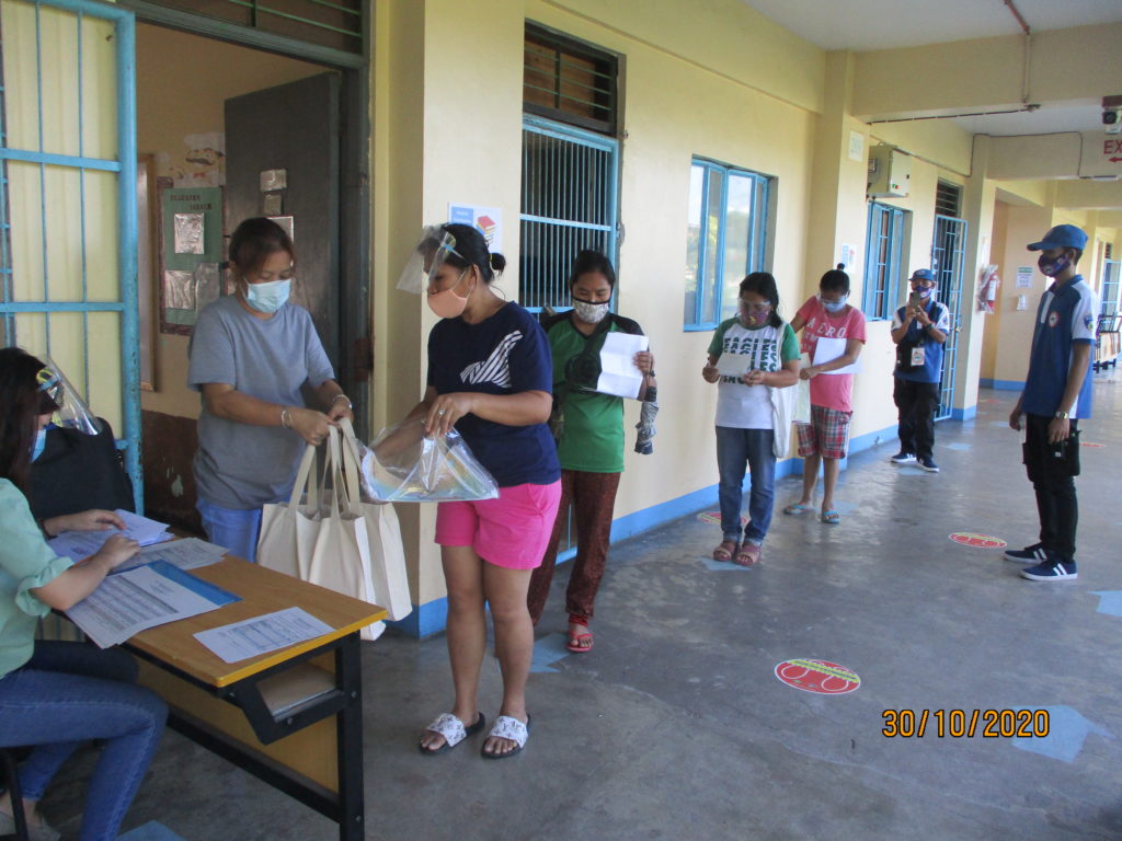 families in need waiting to get emergency food hygiene kits and support