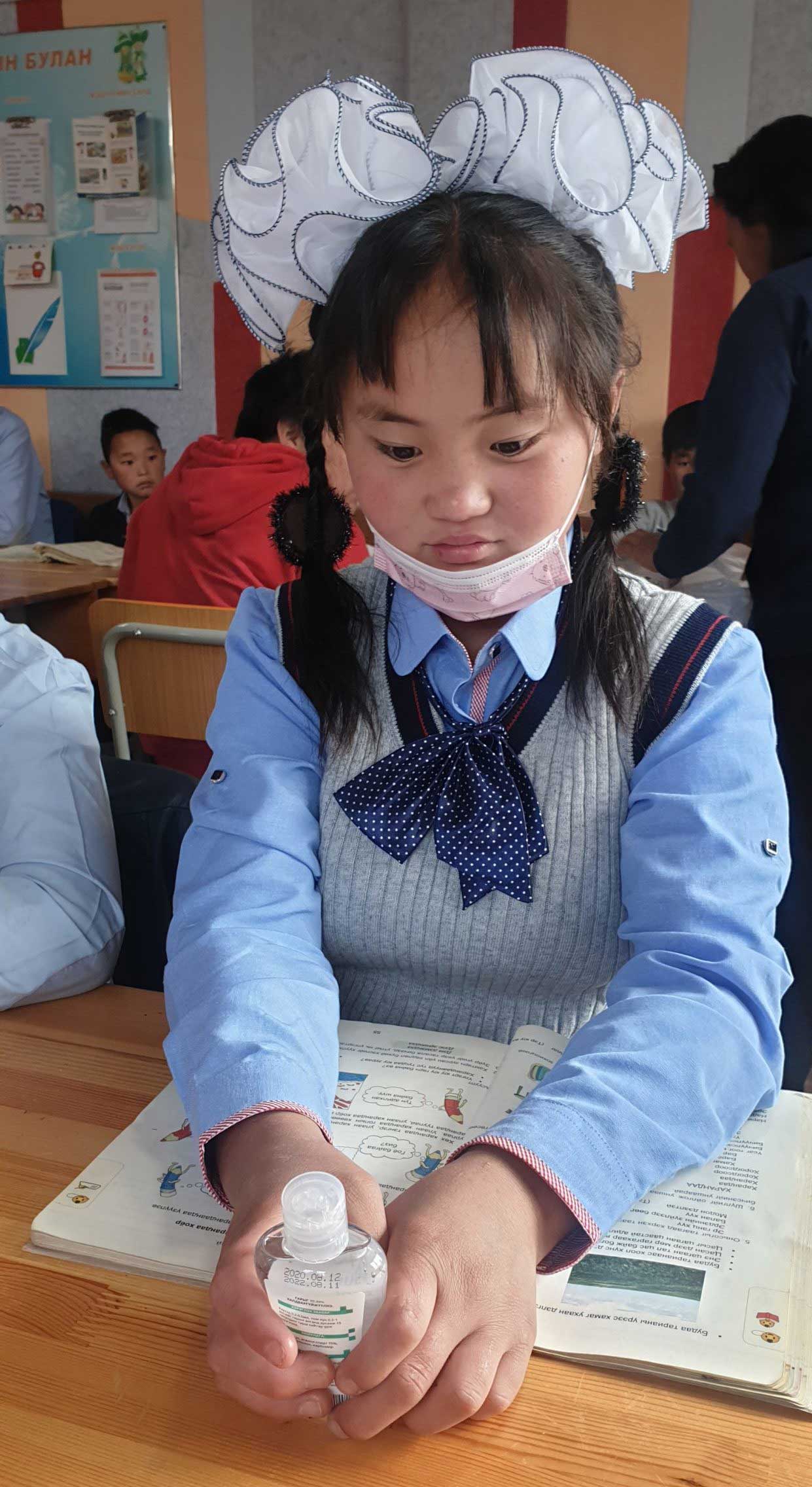 Mongolian girl wearing big bow in school