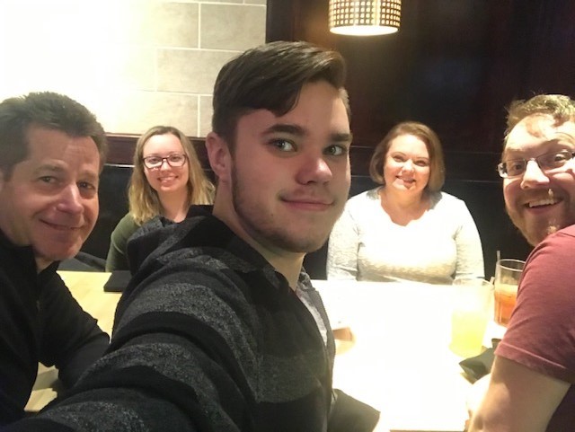 selfie of five people at a restaurant