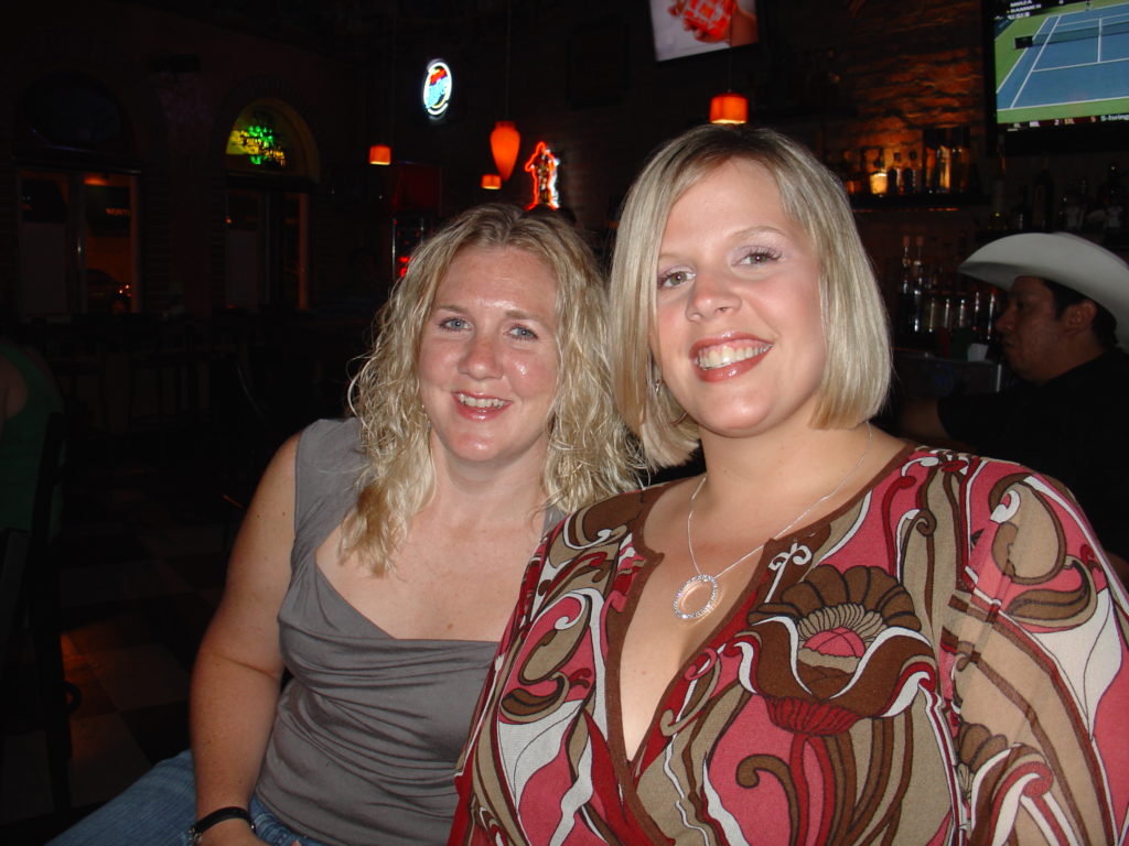 two blonde women smiling at camera