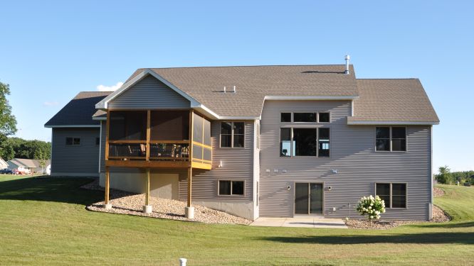 two story grey house with sun porch
