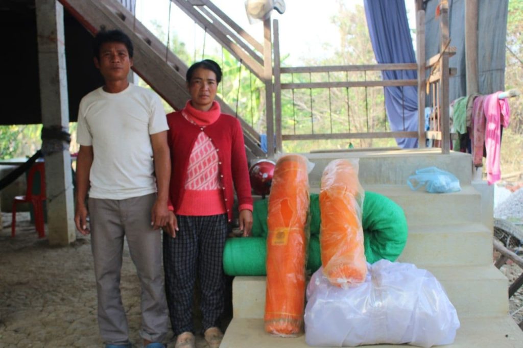man and woman standing by supplies