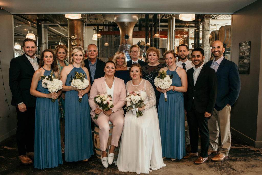 group of people smiling in wedding formal wear