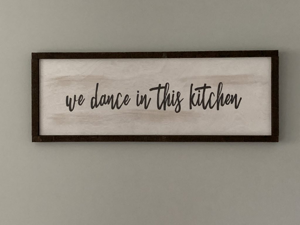 sign that says "we dance in this kitchen"