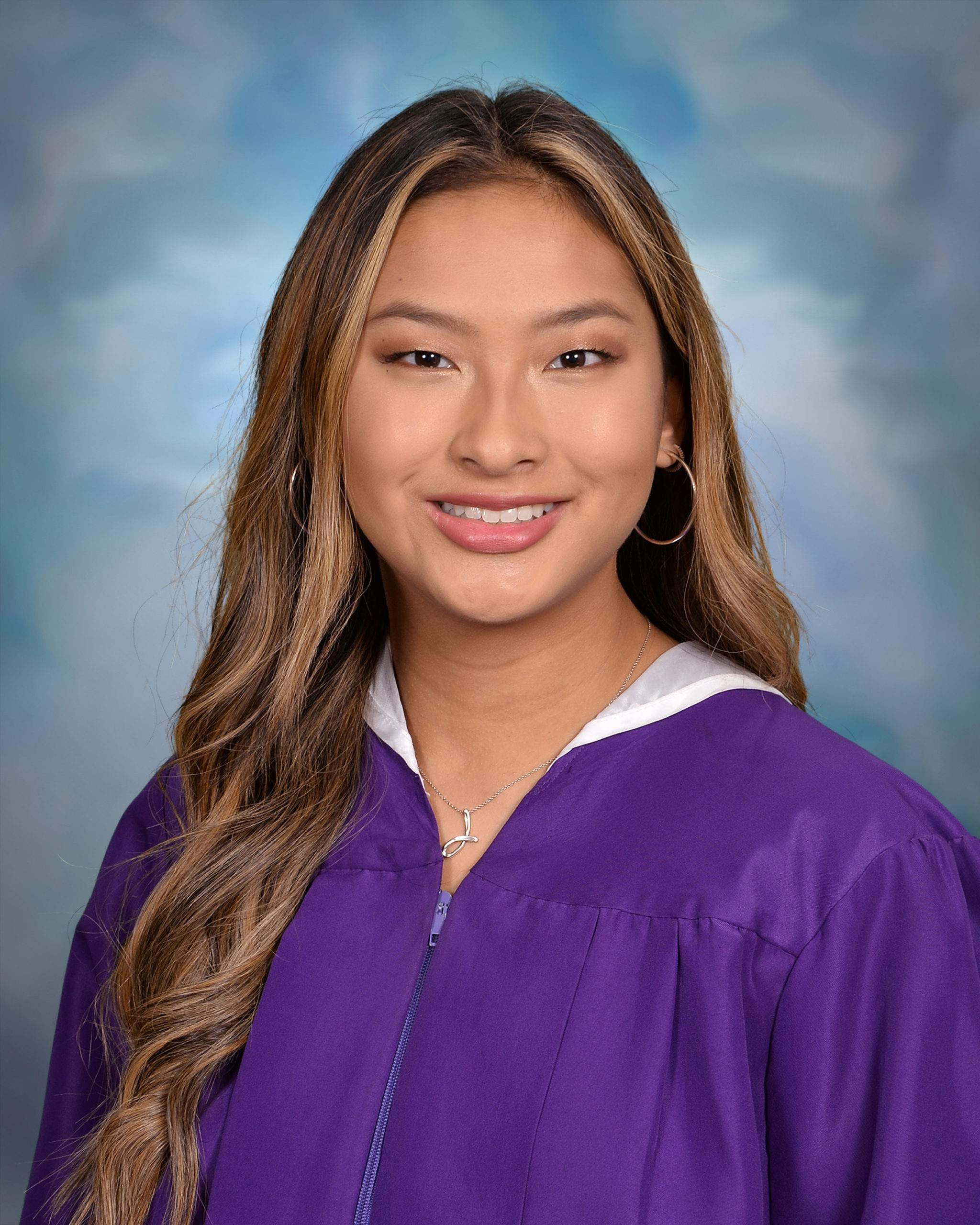 smiling girl wearing purple graduation gown