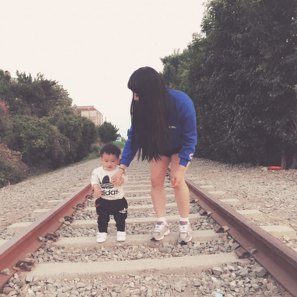 mother walking her young son holding hands