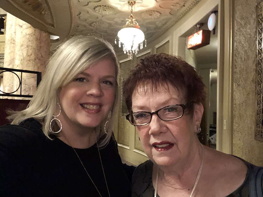 blonde woman and redheaded woman smiling