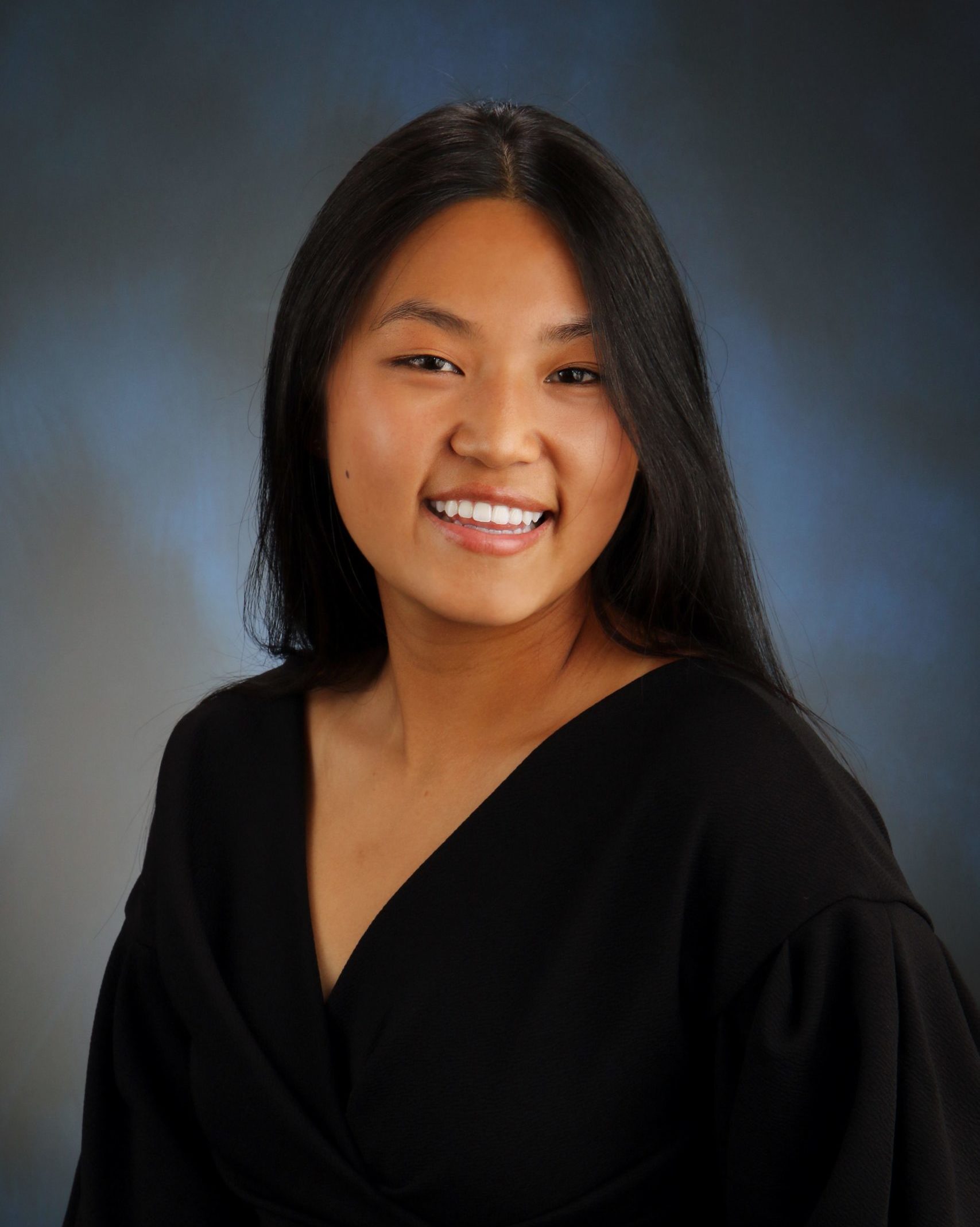 school photo of smiling girl wearing black v-neck shirt