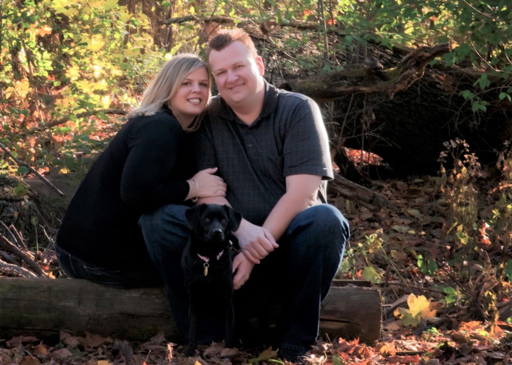 woman man and small black dog
