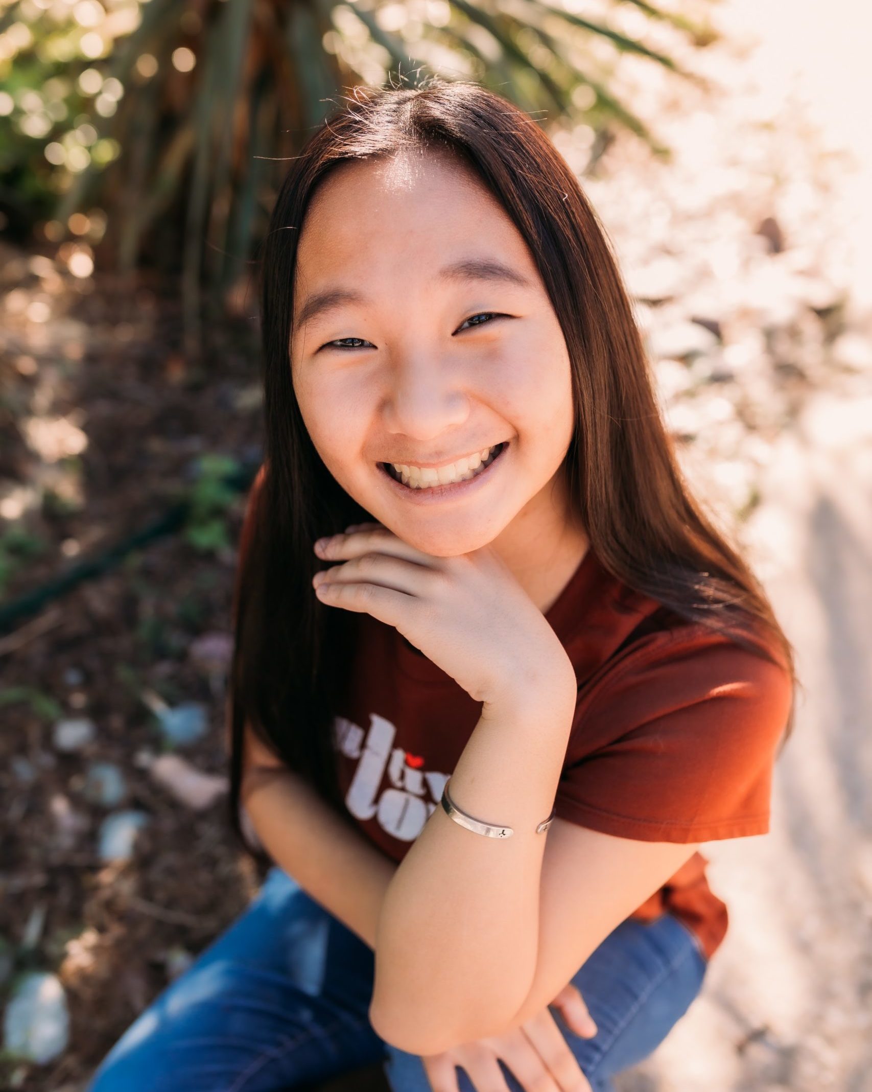 aerial photo of smiling girl wearing red shirt and jeans