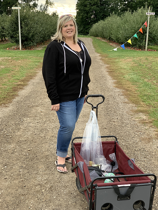woman standing behind a picnic wagon