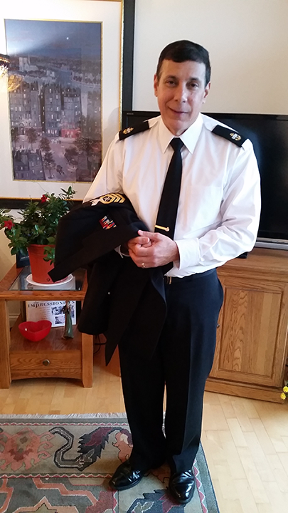 man standing in living room in uniform
