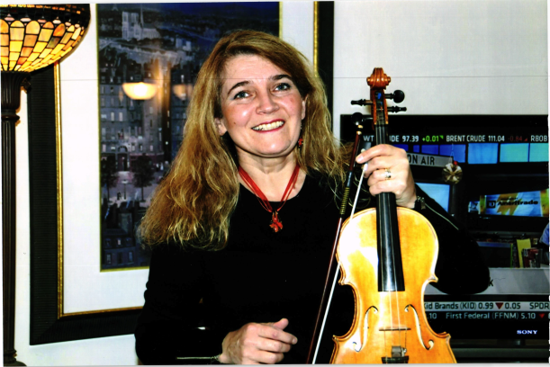 smiling blonde woman holding violin