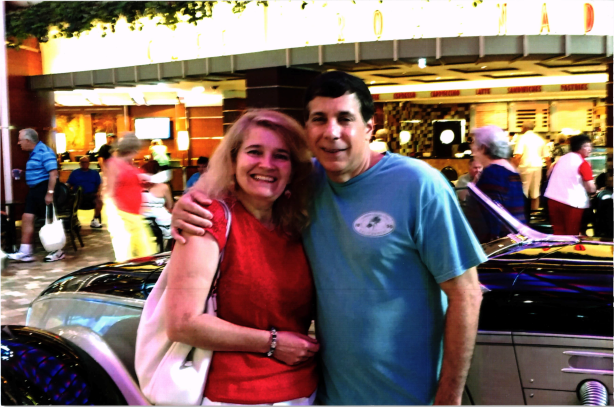 smiling man with arm around smiling woman