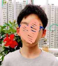 boy wearing blue glasses with face obscured by heart graphic
