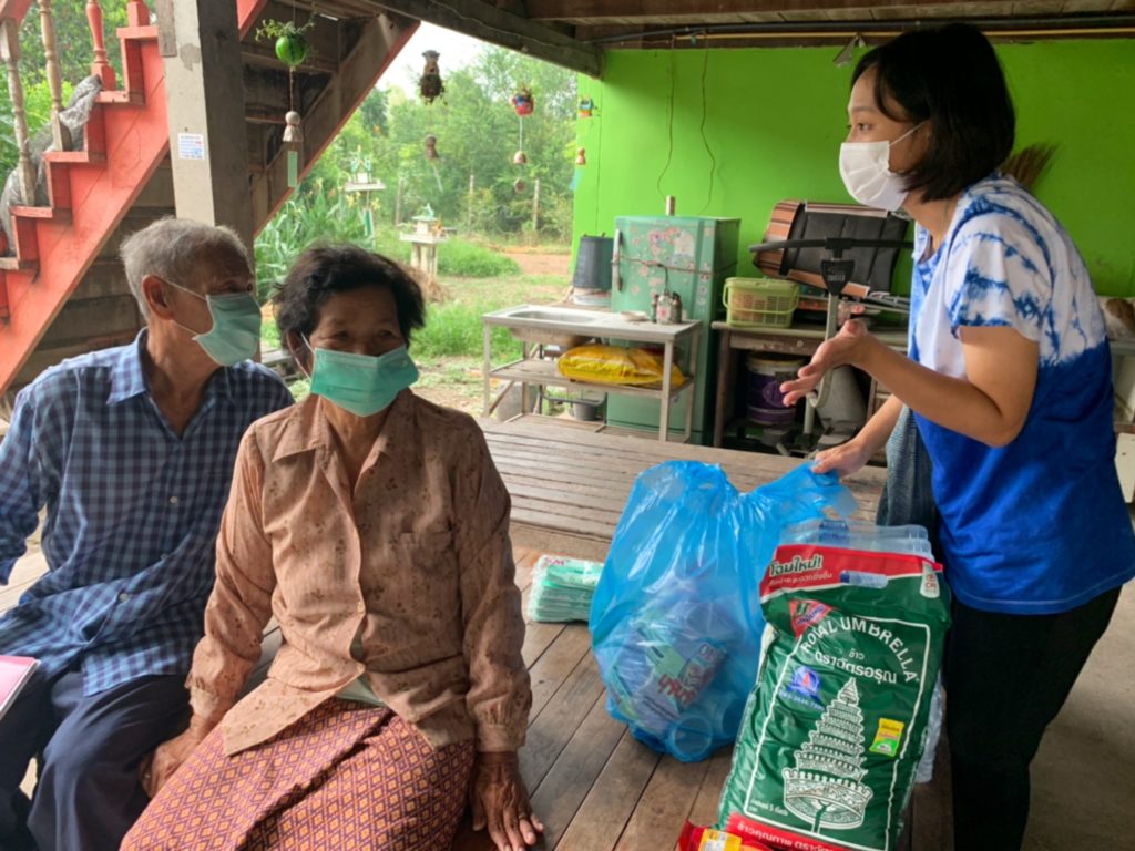 woman delivering food to an older man and woman