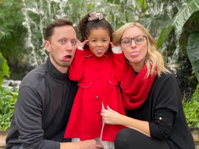man woman and little girl making funny faces