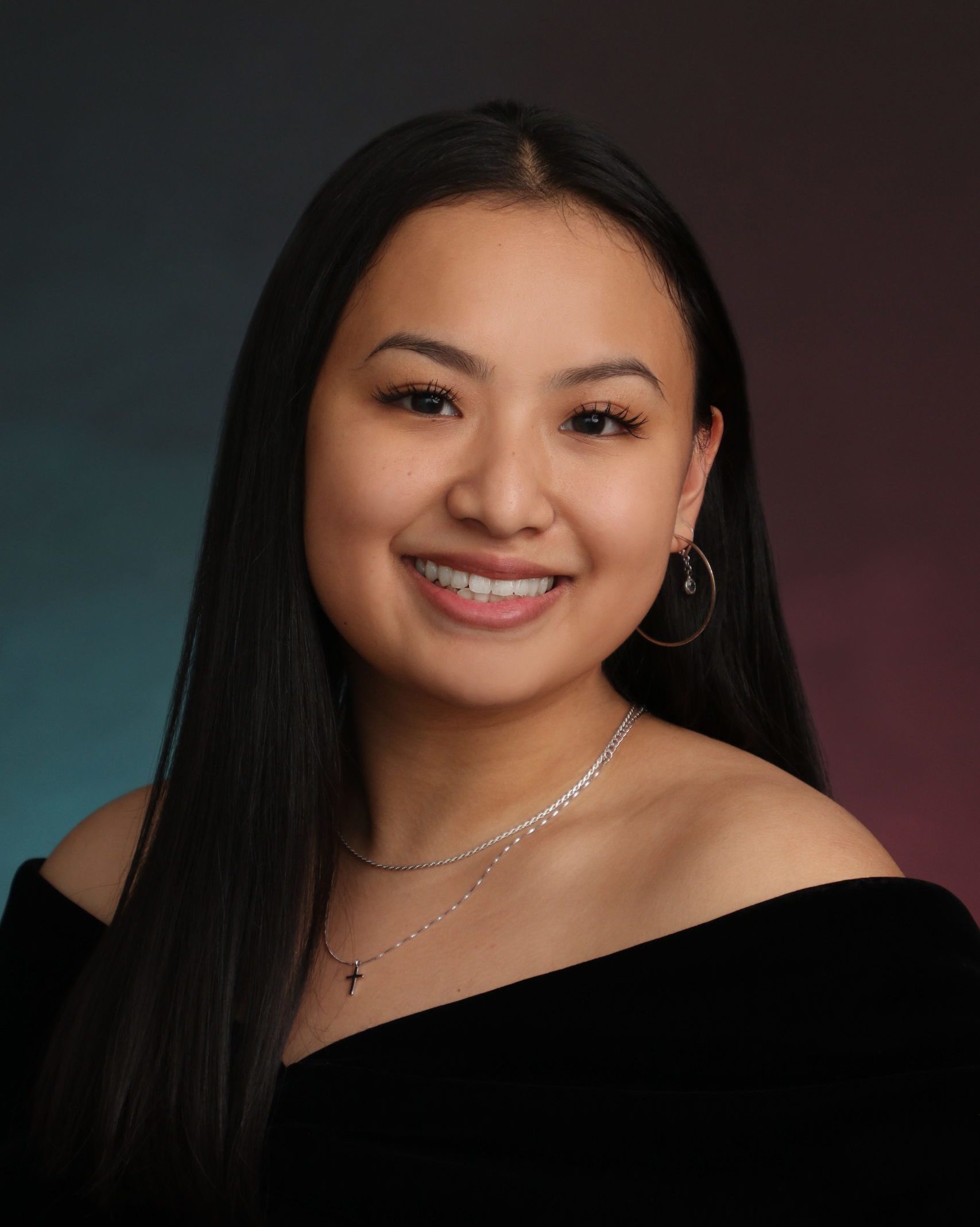 school photo of smiling girl wearing black off the shoulder top