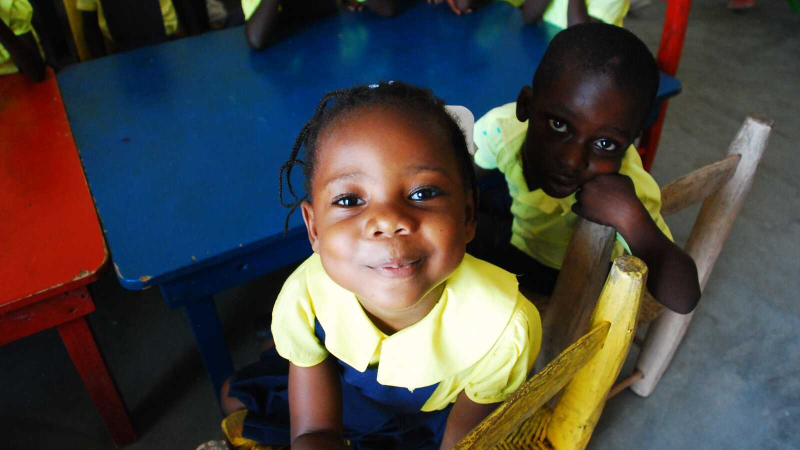 sponsored child in Haiti poses for photo in school