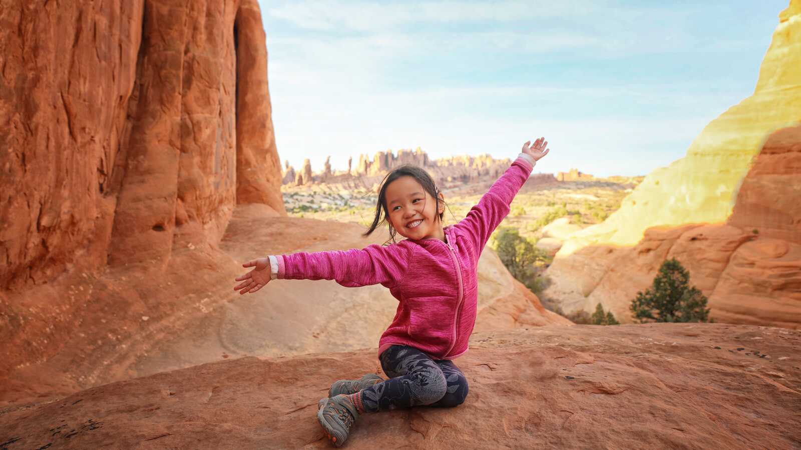 Adopted Chinese girl on rock