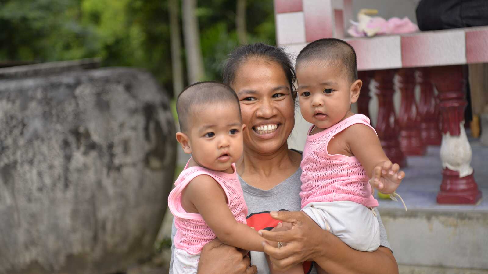 mother holding twins in Thailand