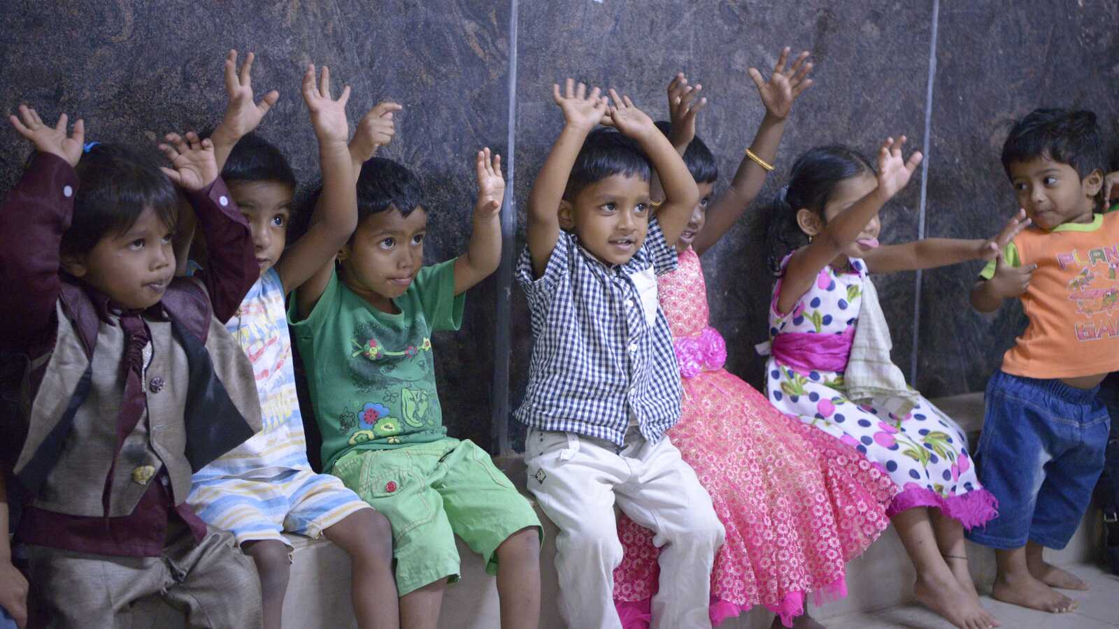 Children raising hands in India