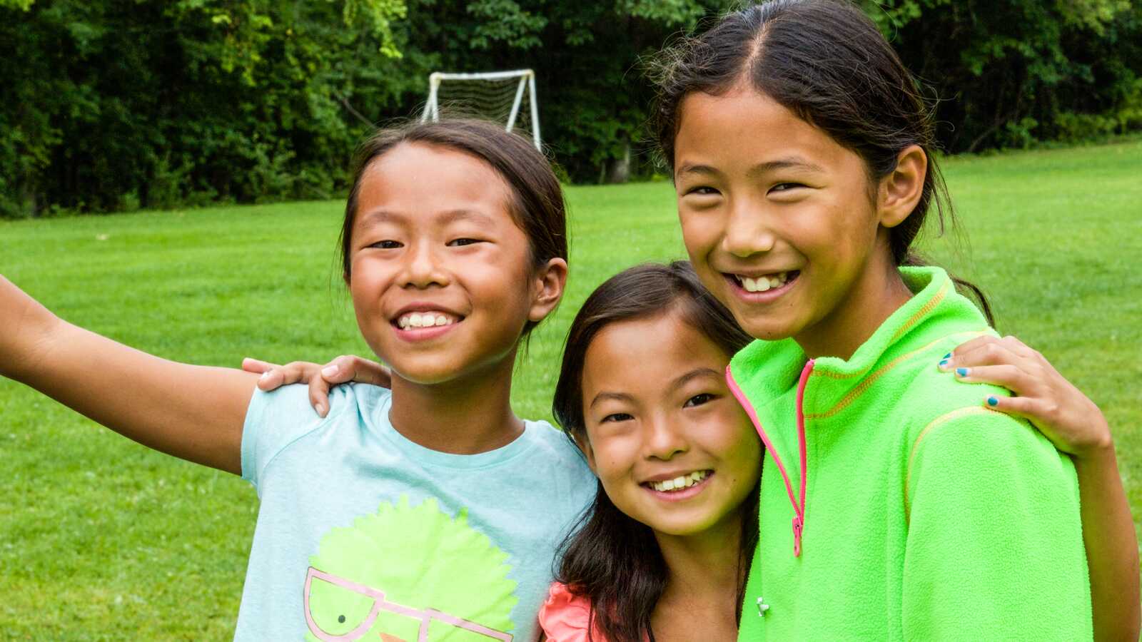 three girls smiling for camera