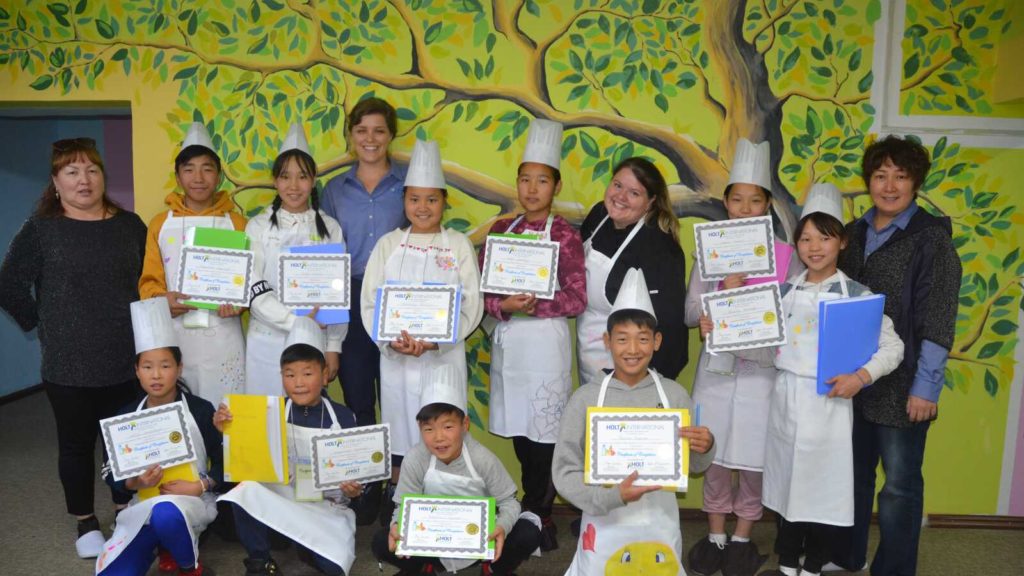 children holding awards in chef hats