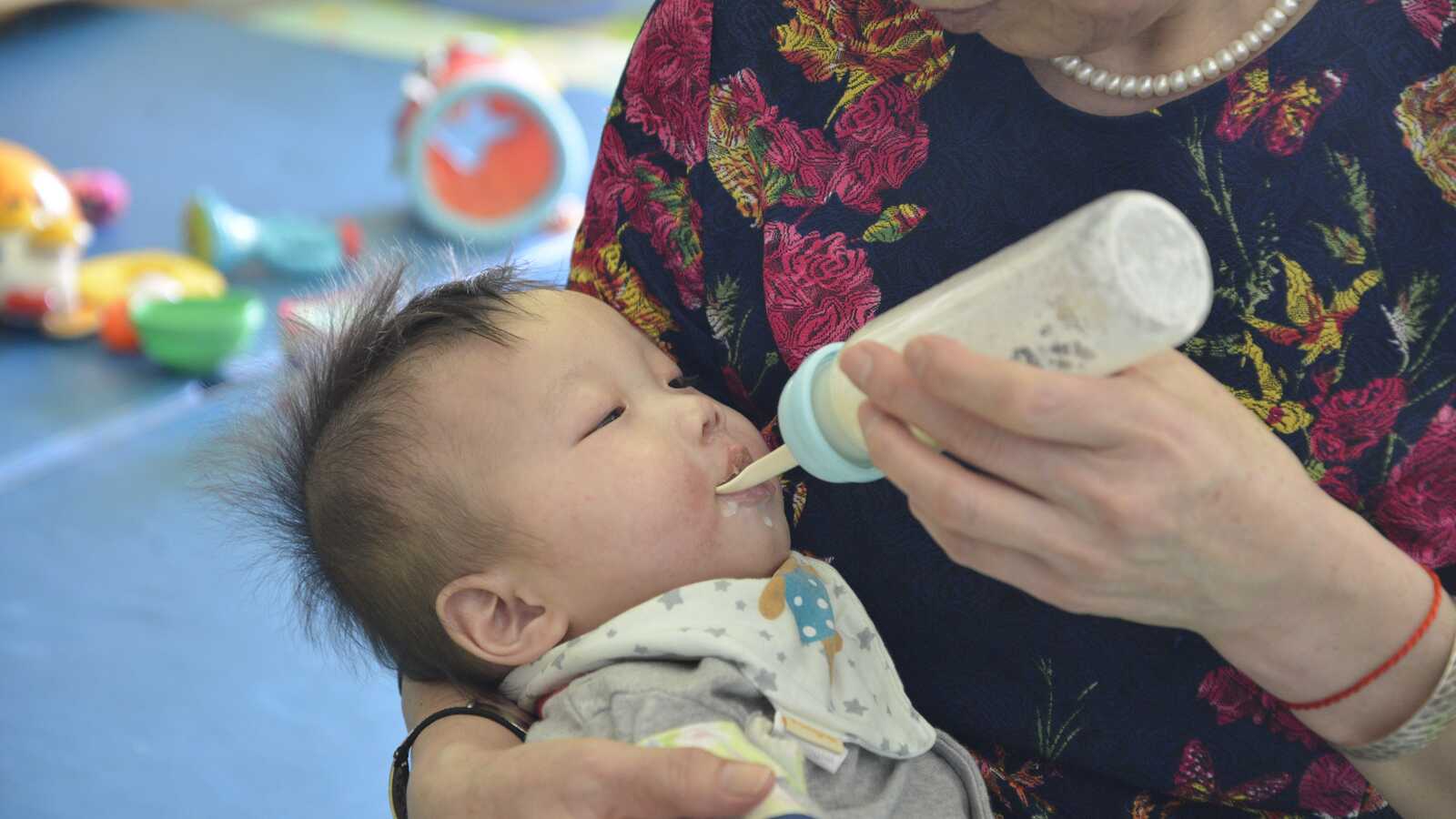 woman feeding baby