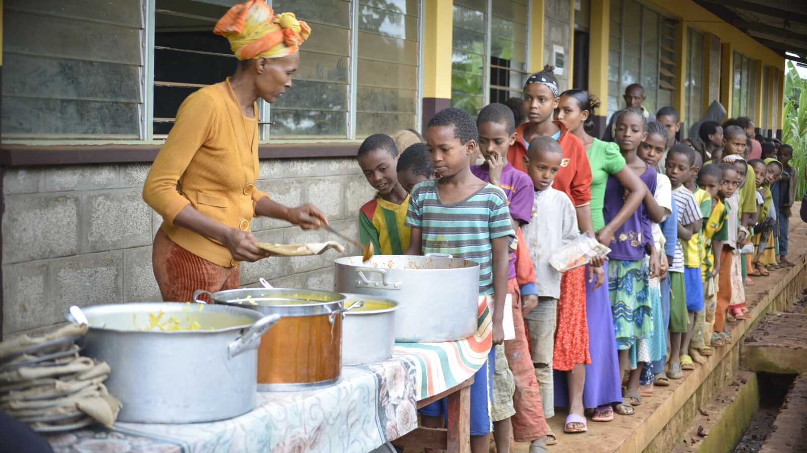 Ethiopian children lining up for lunch at school