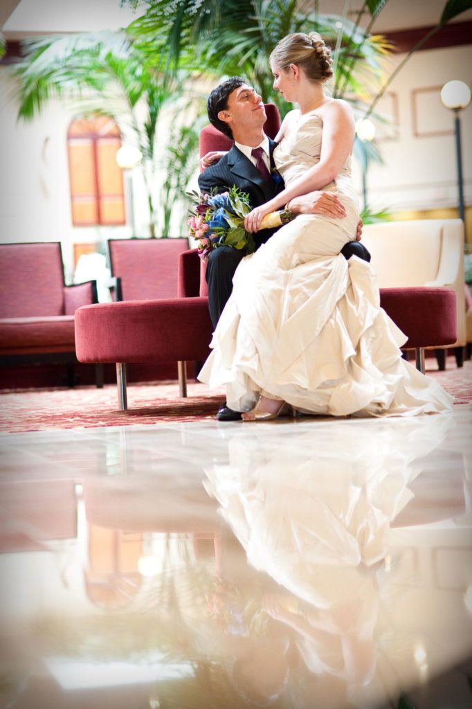 woman in wedding dress sitting with man in suit