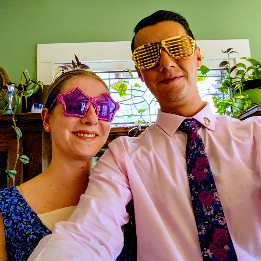 man and woman in glittery sunglasses