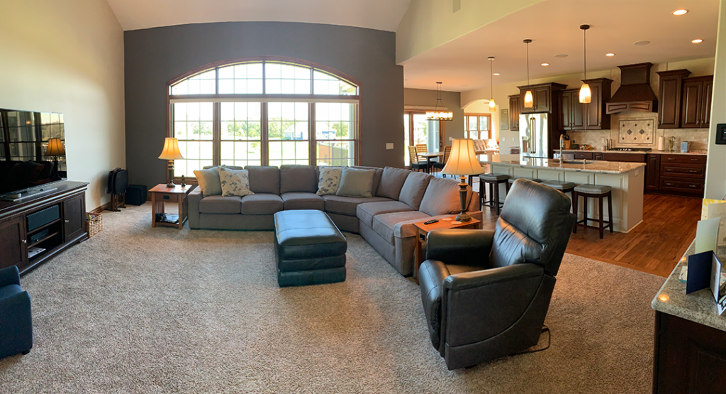 open floor plan kitchen and living room with grey sectional