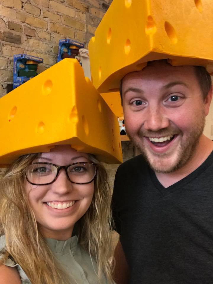 man and woman with hats shaped like blocks of cheese
