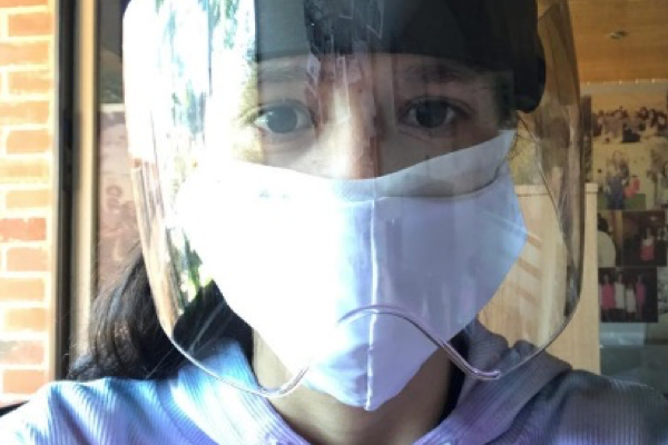 caregiver wearing mask and face shield