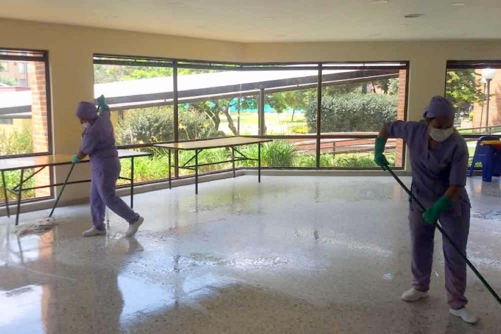 two people cleaning the floor