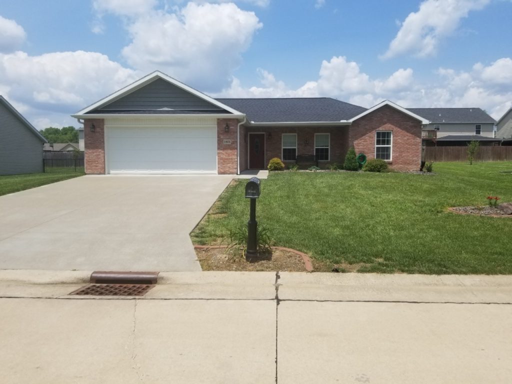 red brick house with white trim and white garage