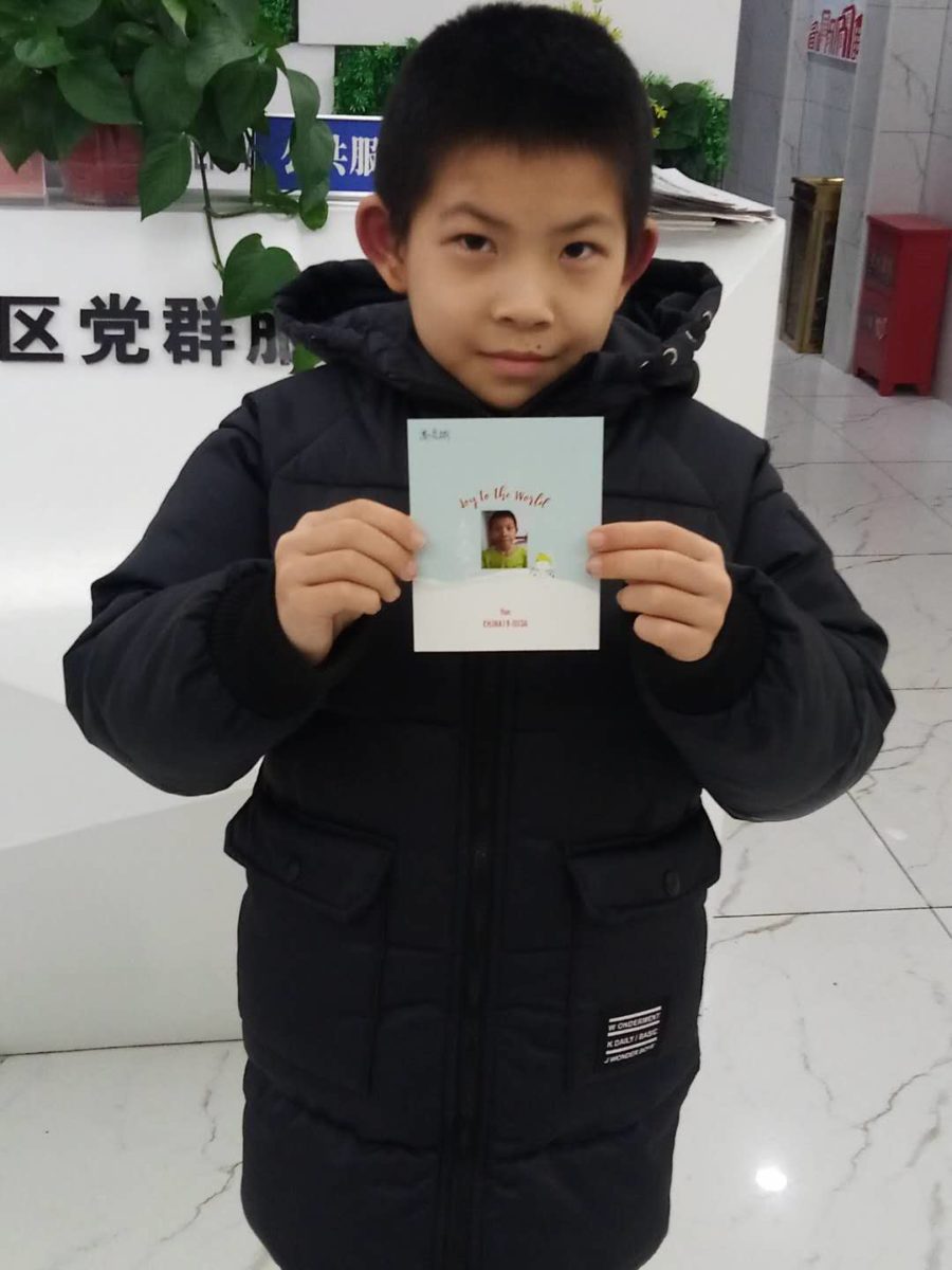 boy holding Christmas card