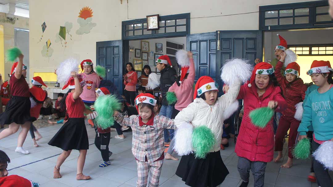 Children dancing in Santa hats