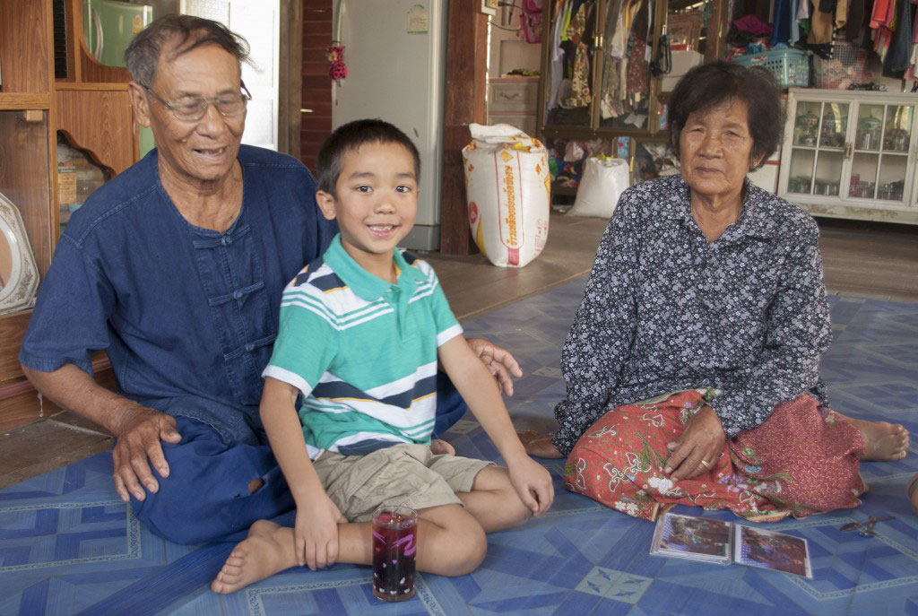 Thai foster parents with former foster child now adopted
