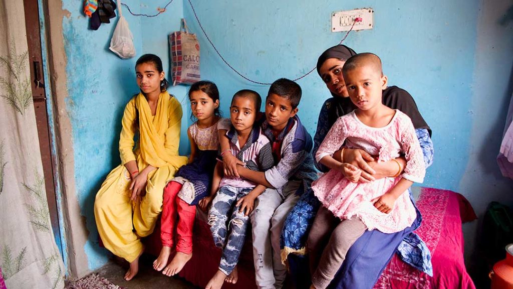 Anjum (left) with her siblings and mother in their apartment in Delhi.