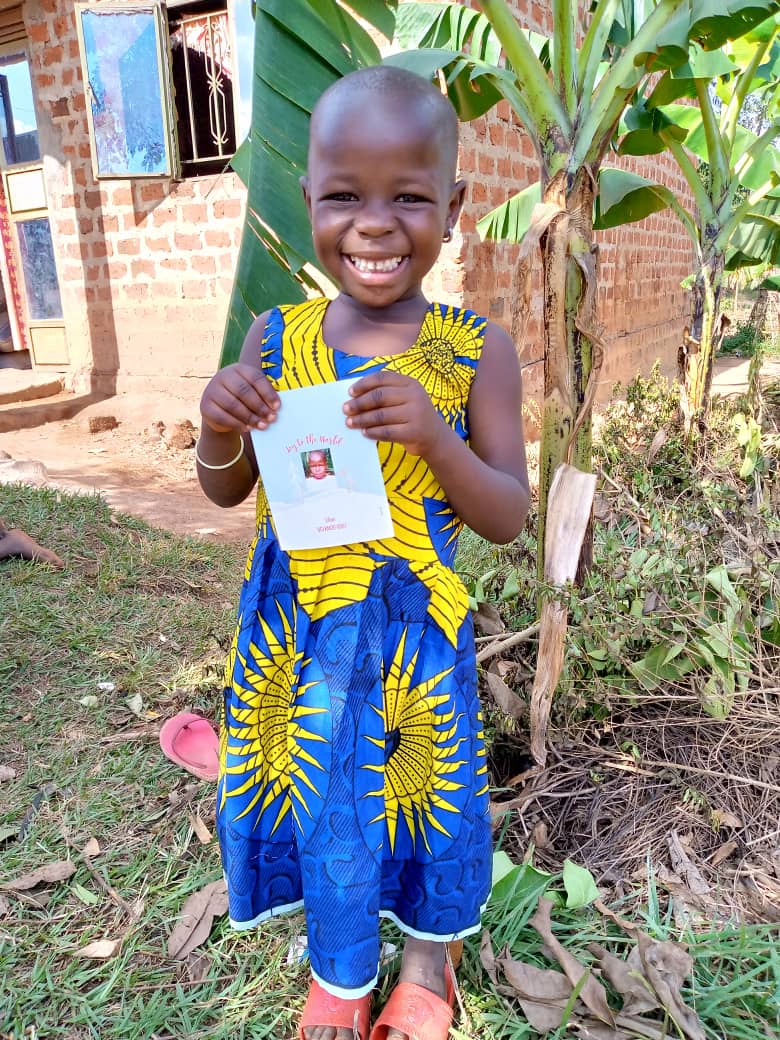 Girl holding Christmas card in Uganda