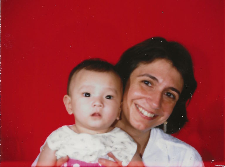 Laura and baby Eleni taking an exit visa photo in China.