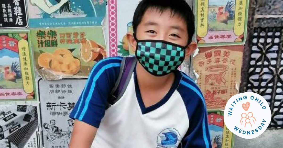 smiling niko who needs an adoptive family wearing checkered face mask