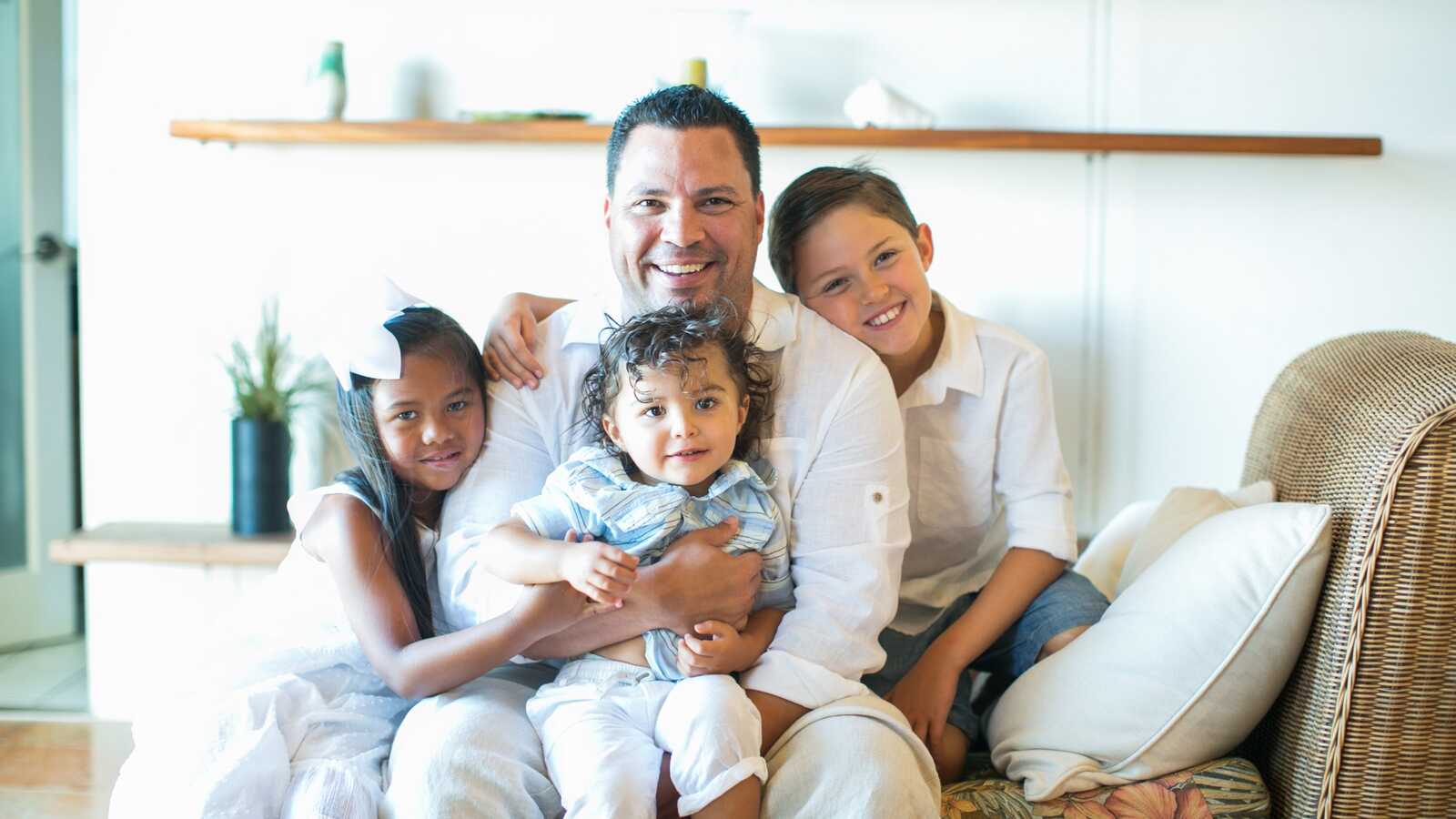 father poses with Children including two from Korea