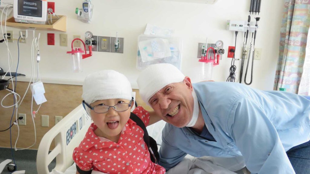 adopted girl from china in hospital with fathers for eeg head tests