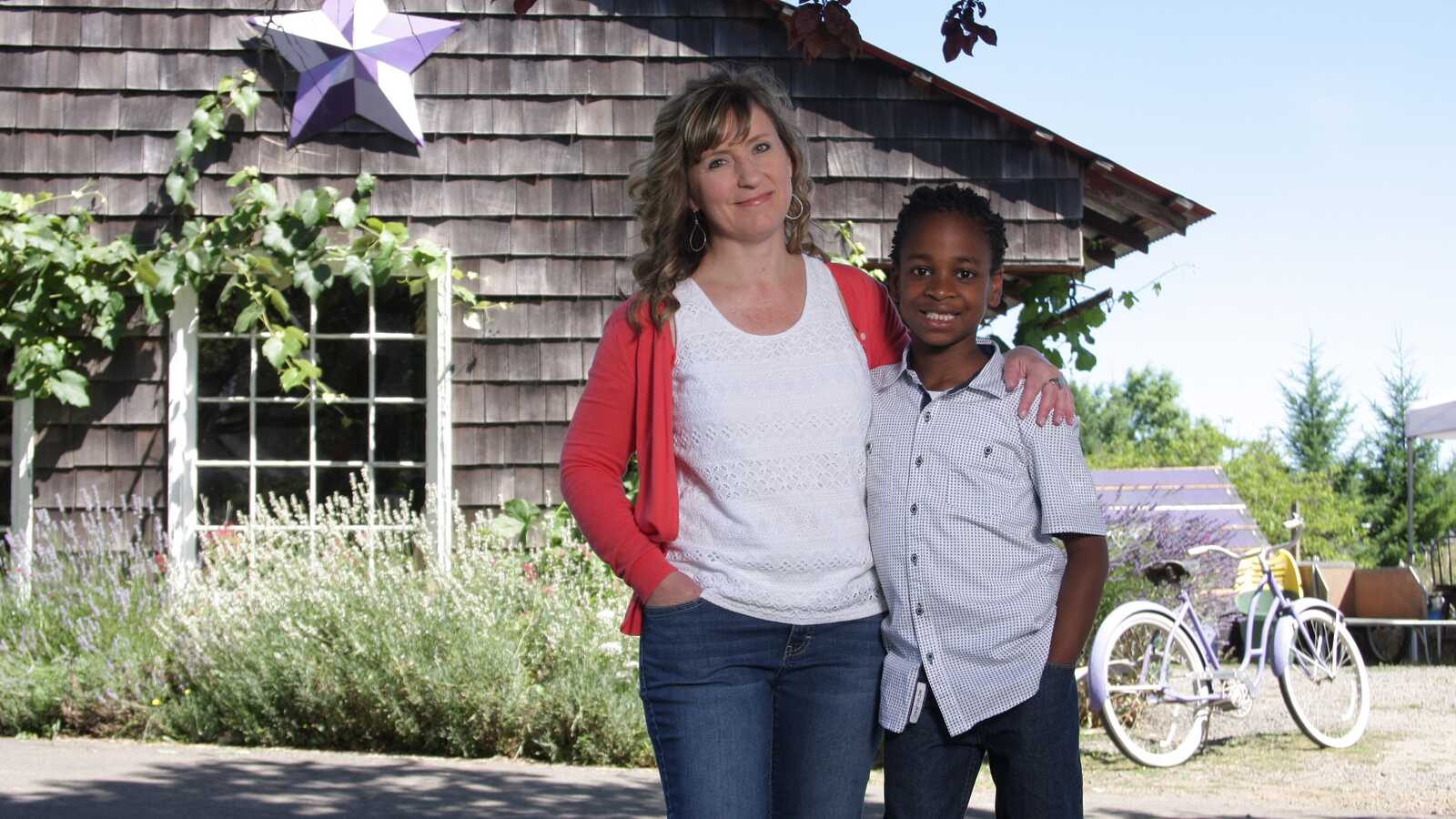 mother poses with adopted son from Haiti
