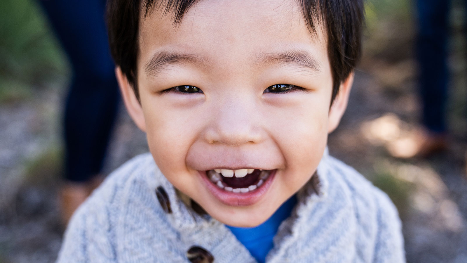 boy adopted from korea smiling close to camera